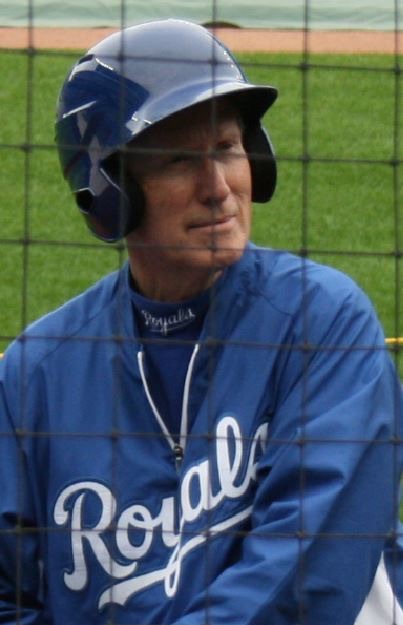 Larry in a Royals helmet and jacket on the field during batting practice